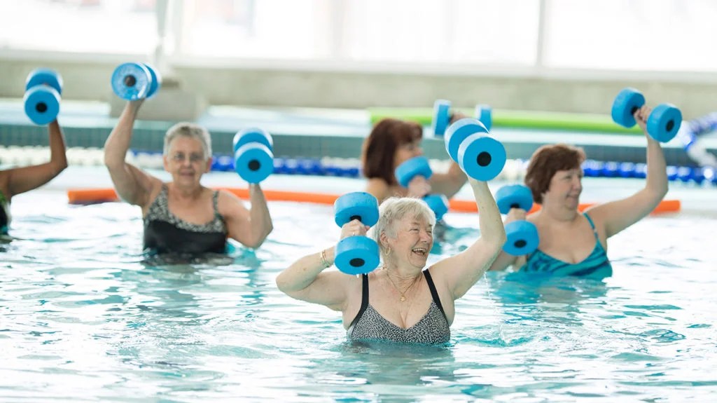 older adults doing exercises in a swimming pool as one of the natural ways to lower blood pressure