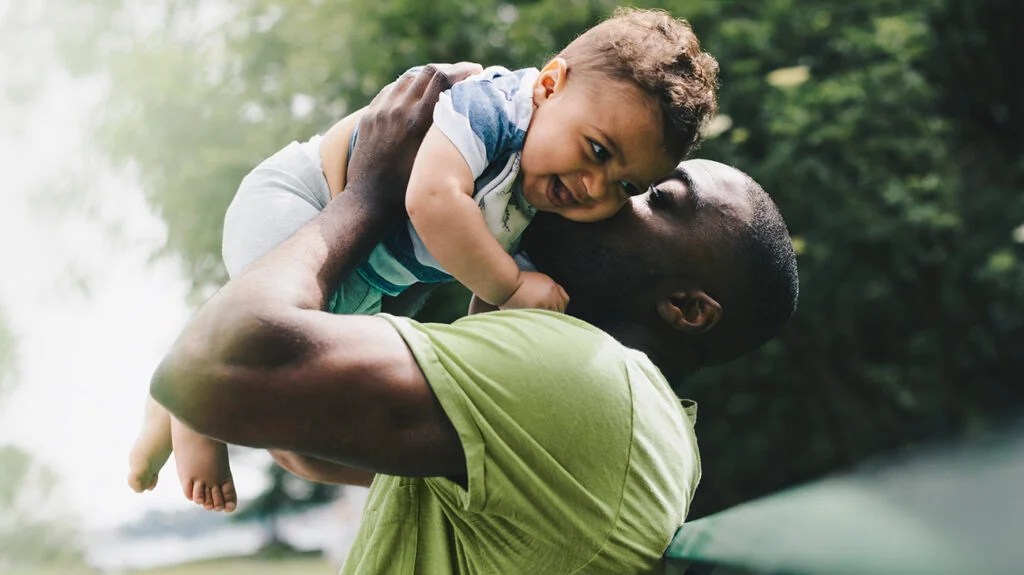 A man lifting a baby. -1